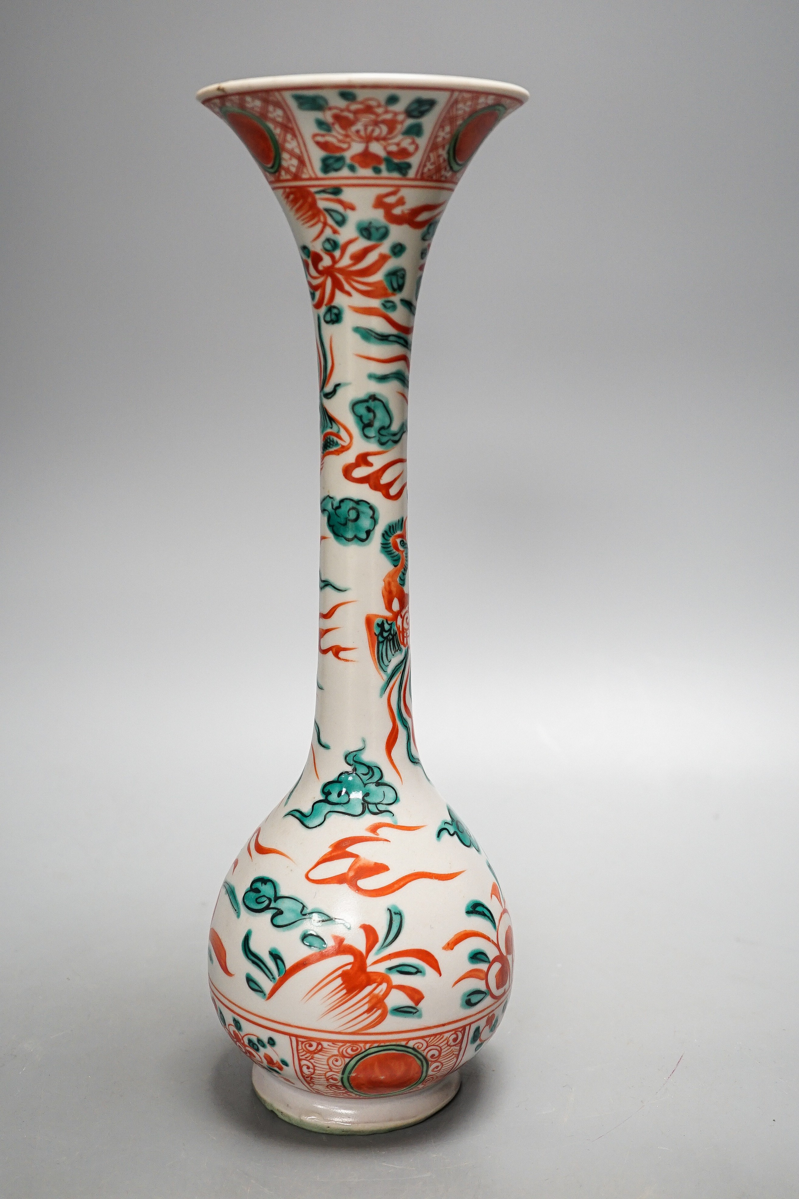 A Chinese Swatow style bottle vase, painted in green and iron red enamels with phoenixes amid flowers and clouds, 31.5cm